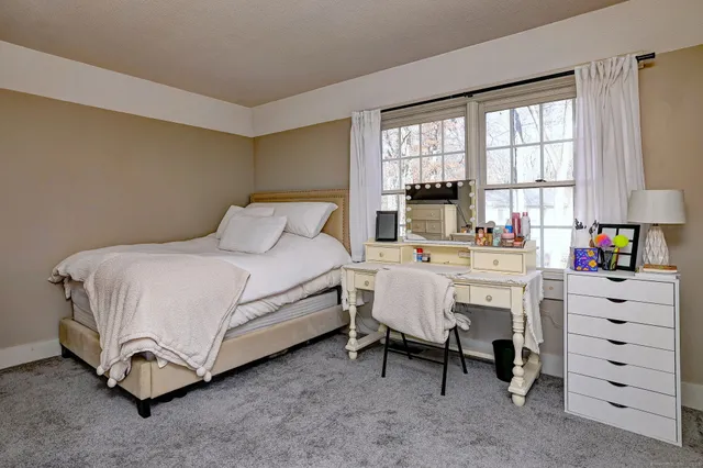 a bedroom with a bed and a lamp on table