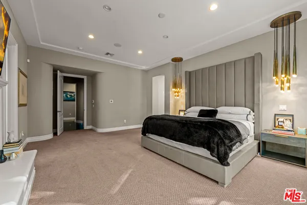 a spacious bedroom with a bed and a window