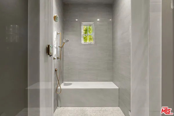 a bathroom with a bathtub and shower