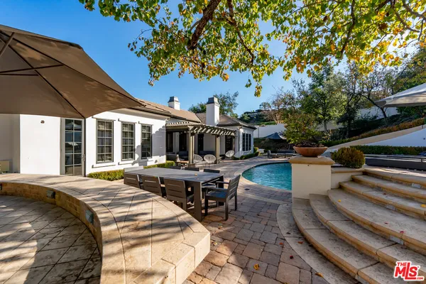 a view of a patio with swimming pool table and chairs