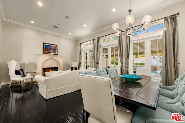 a living room with furniture a chandelier and a table