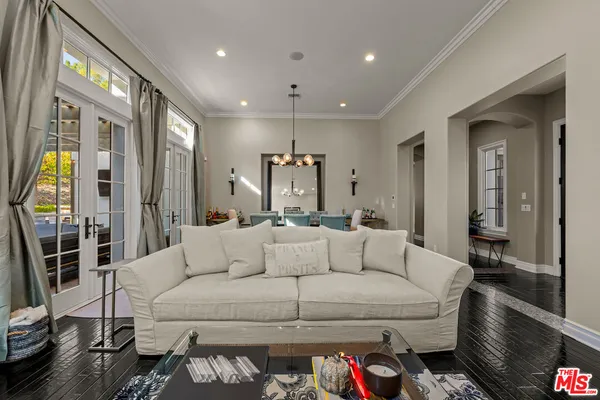 a living room with furniture and a glass door
