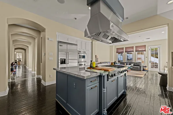 a kitchen with stainless steel appliances granite countertop a stove and cabinets