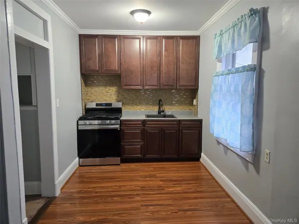 a kitchen with a sink and a refrigerator