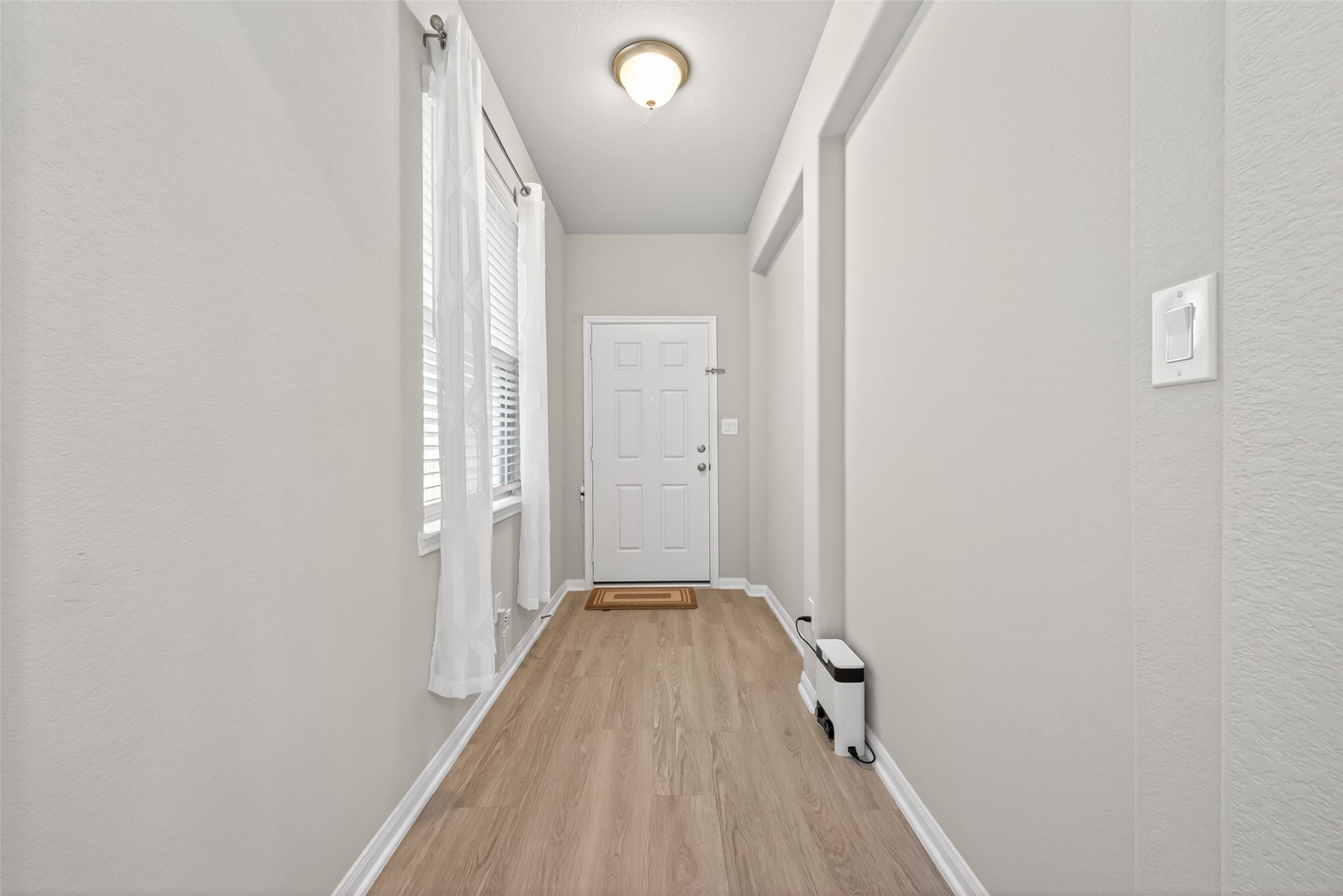22409 Kinley Street New Caney, TX 77357 - Photo 11 of 46 a view of a hallway with wooden floor