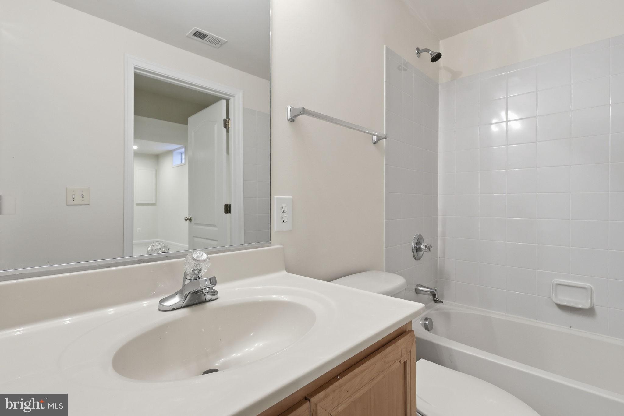 19617 Edgemont Square Ashburn, VA 20147 - Photo 48 of 65 a bathroom with a sink and a mirror