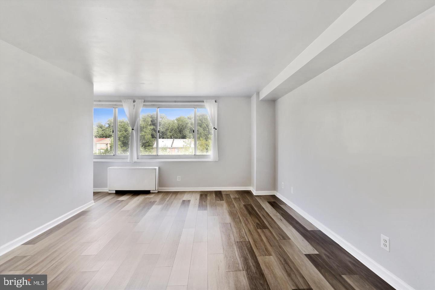 1900 Lyttonsville Road, Unit 602 Silver Spring, MD 20910 - Photo 4 of 43 wooden floor in an empty room with a window