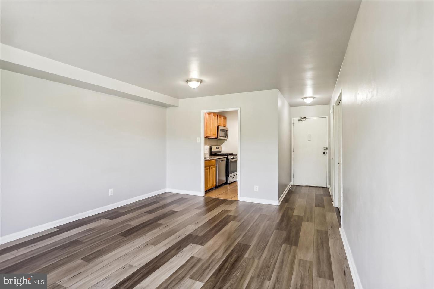 1900 Lyttonsville Road, Unit 602 Silver Spring, MD 20910 - Photo 8 of 43 a view of a big room with wooden floor and windows