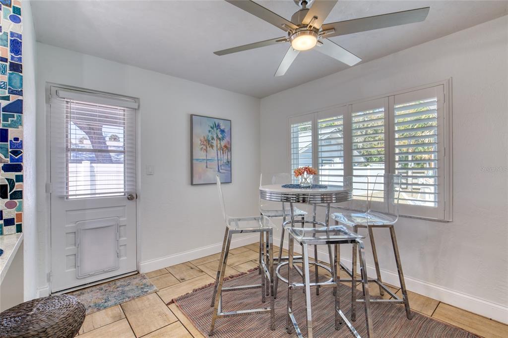 1127 Indigo Road Ormond Beach, FL 32174 - Photo 15 of 94 a dining room with chandelier and wooden floor