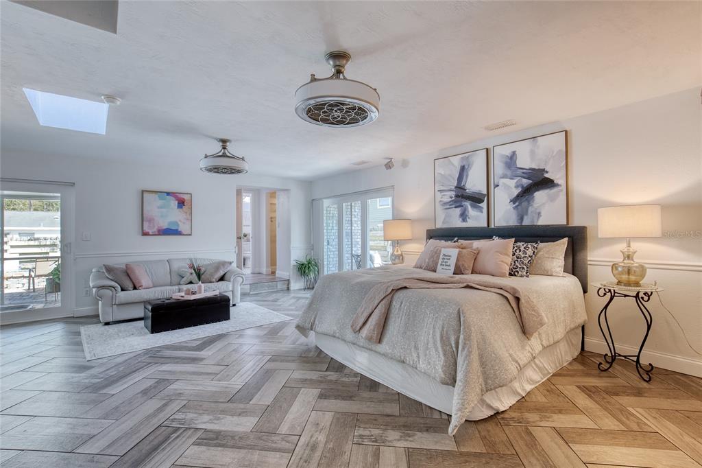 1127 Indigo Road Ormond Beach, FL 32174 - Photo 22 of 94 a spacious bedroom with a bed mirror and couch