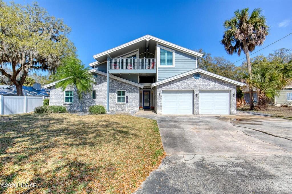1127 Indigo Road Ormond Beach, FL 32174 - Photo 3 of 94 a front view of a house with a yard and garage