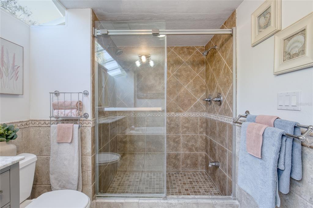 1127 Indigo Road Ormond Beach, FL 32174 - Photo 35 of 94 a bathroom with a shower and a toilet