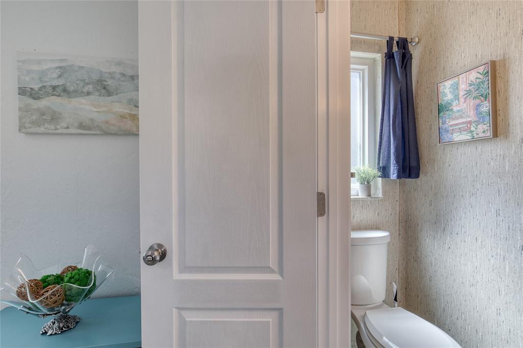 1127 Indigo Road Ormond Beach, FL 32174 - Photo 44 of 94 a bathroom with a toilet a sink and mirror