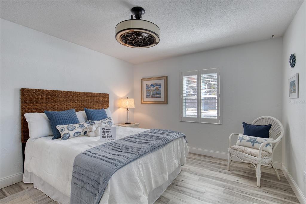 1127 Indigo Road Ormond Beach, FL 32174 - Photo 46 of 94 a bedroom with a bed and a chair