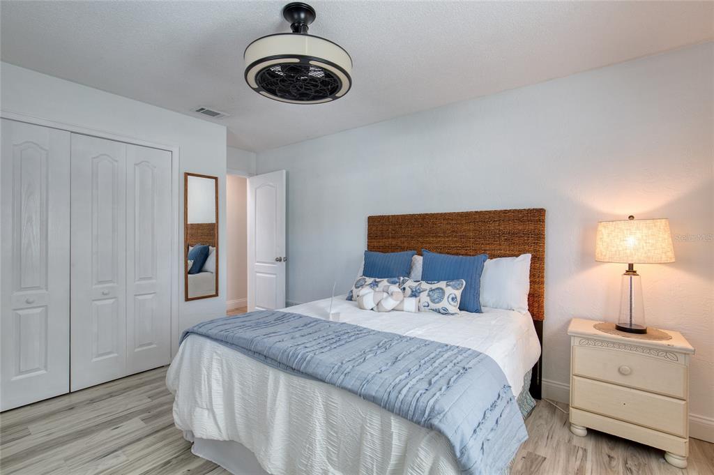 1127 Indigo Road Ormond Beach, FL 32174 - Photo 47 of 94 a bedroom with a bed and a chandelier