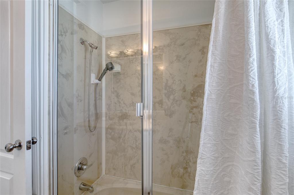 1127 Indigo Road Ormond Beach, FL 32174 - Photo 49 of 94 a bathroom with a glass shower door