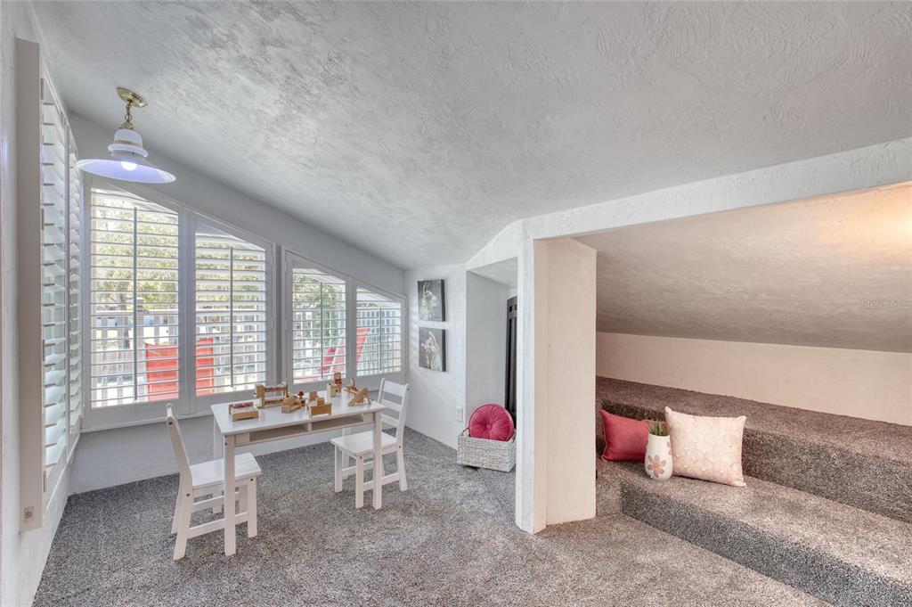 1127 Indigo Road Ormond Beach, FL 32174 - Photo 54 of 94 a room with lots of wooden furniture and windows