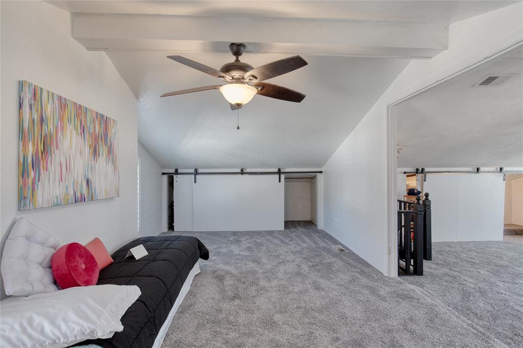 1127 Indigo Road Ormond Beach, FL 32174 - Photo 58 of 94 a livingroom with a ceiling fan and a rug