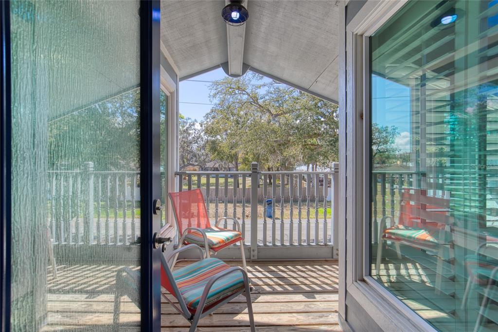1127 Indigo Road Ormond Beach, FL 32174 - Photo 59 of 94 a living room with hardwood floor and a floor to ceiling window