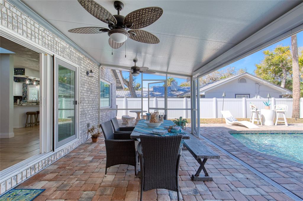 1127 Indigo Road Ormond Beach, FL 32174 - Photo 65 of 94 a dining room with furniture a chandelier and wooden floor