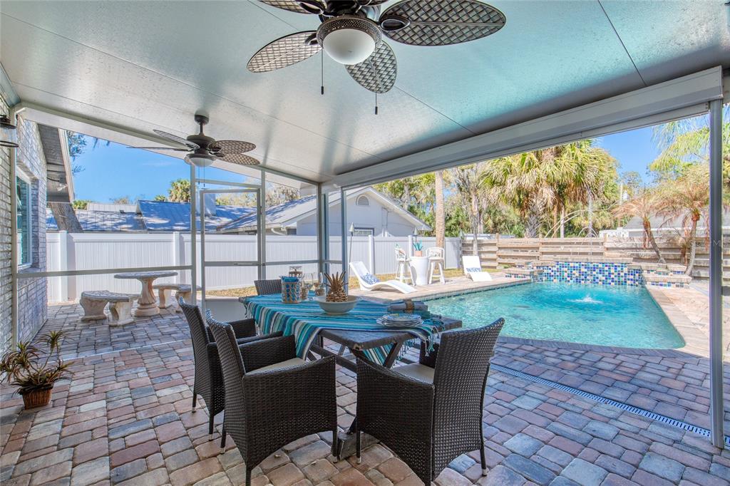 1127 Indigo Road Ormond Beach, FL 32174 - Photo 66 of 94 a dining room with furniture a rug and a floor to ceiling window