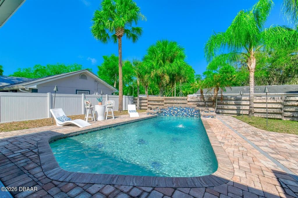 1127 Indigo Road Ormond Beach, FL 32174 - Photo 68 of 94 a front view of house with yard and outdoor seating