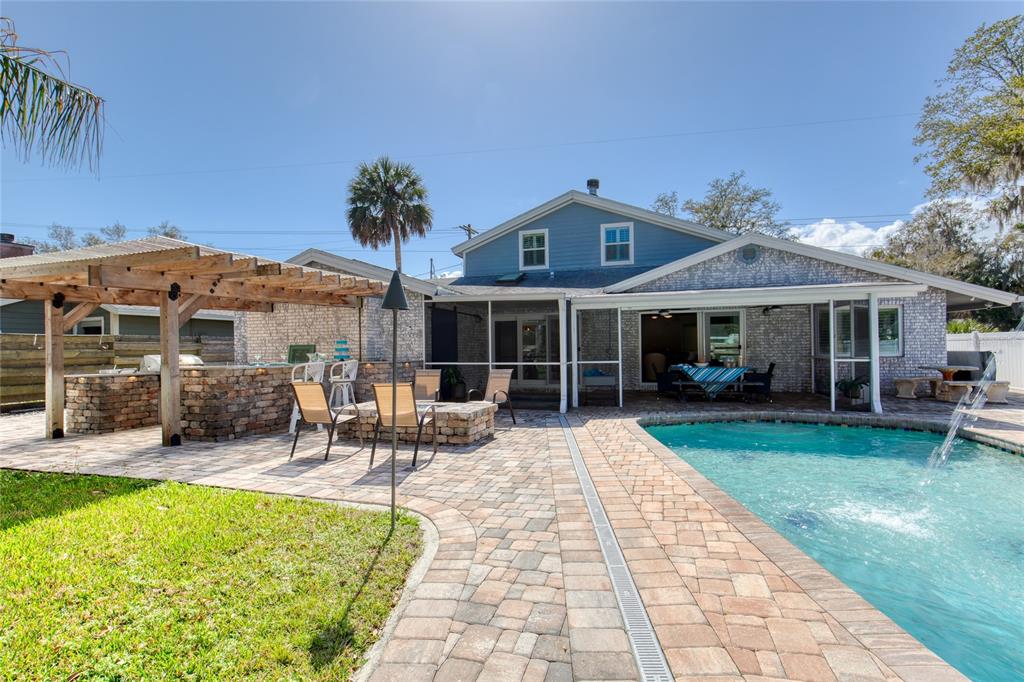 1127 Indigo Road Ormond Beach, FL 32174 - Photo 71 of 94 a front view of a house with a garden and patio