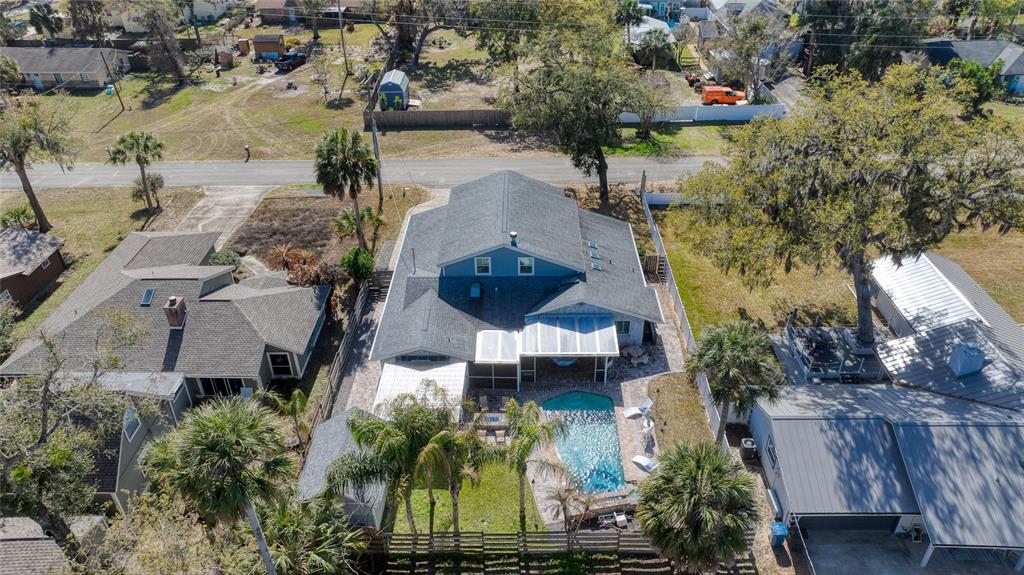 1127 Indigo Road Ormond Beach, FL 32174 - Photo 83 of 94 an aerial view of a house with a yard and lake view