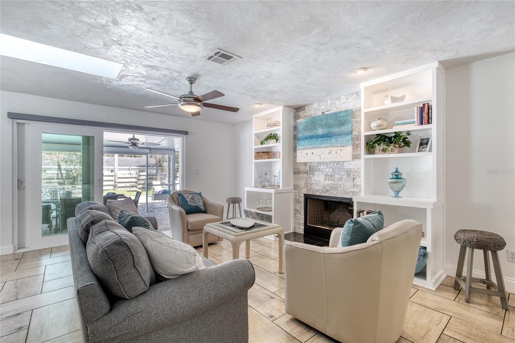 1127 Indigo Road Ormond Beach, FL 32174 - Photo 10 of 94 a living room with furniture a fireplace and a large window