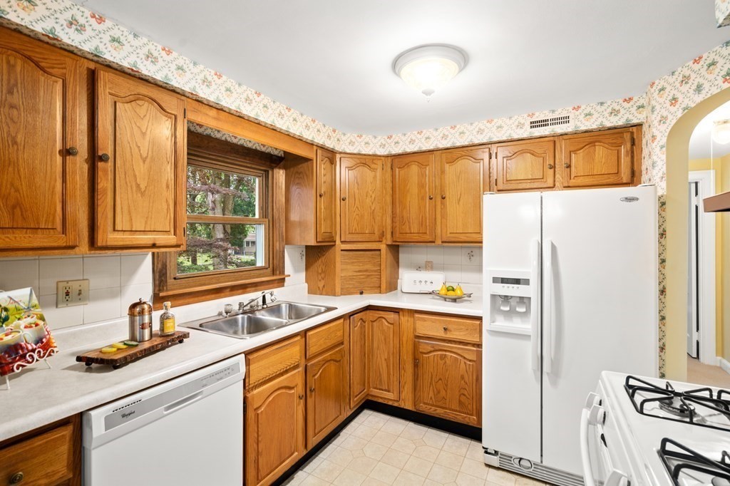 6 Stowecroft Road Arlington, MA 02474 - Photo 8 of 17 a kitchen with a sink stove and refrigerator