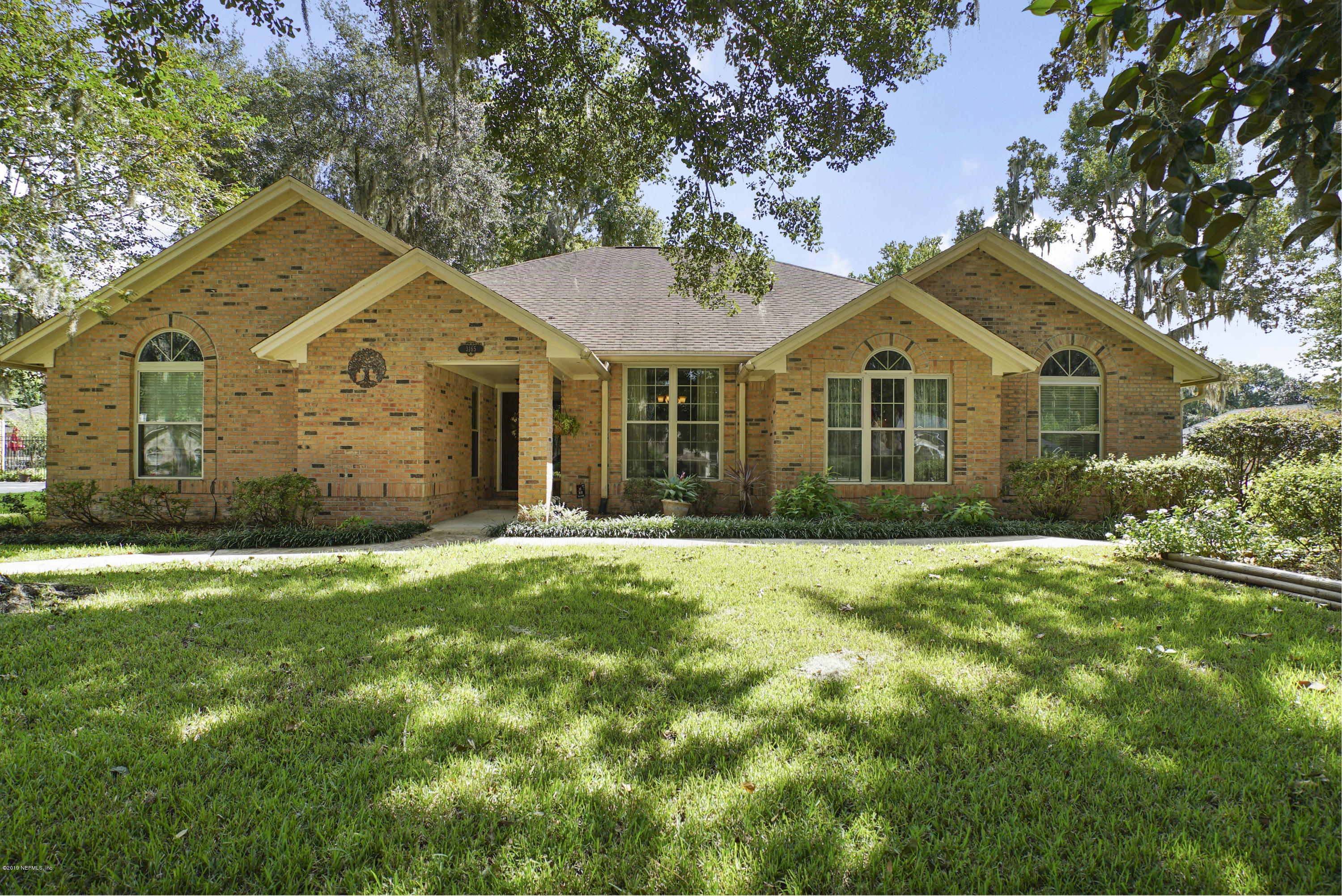 3165 Nautilus Road Middleburg, FL 32068 - Photo 1 of 35 a front view of a house with a garden