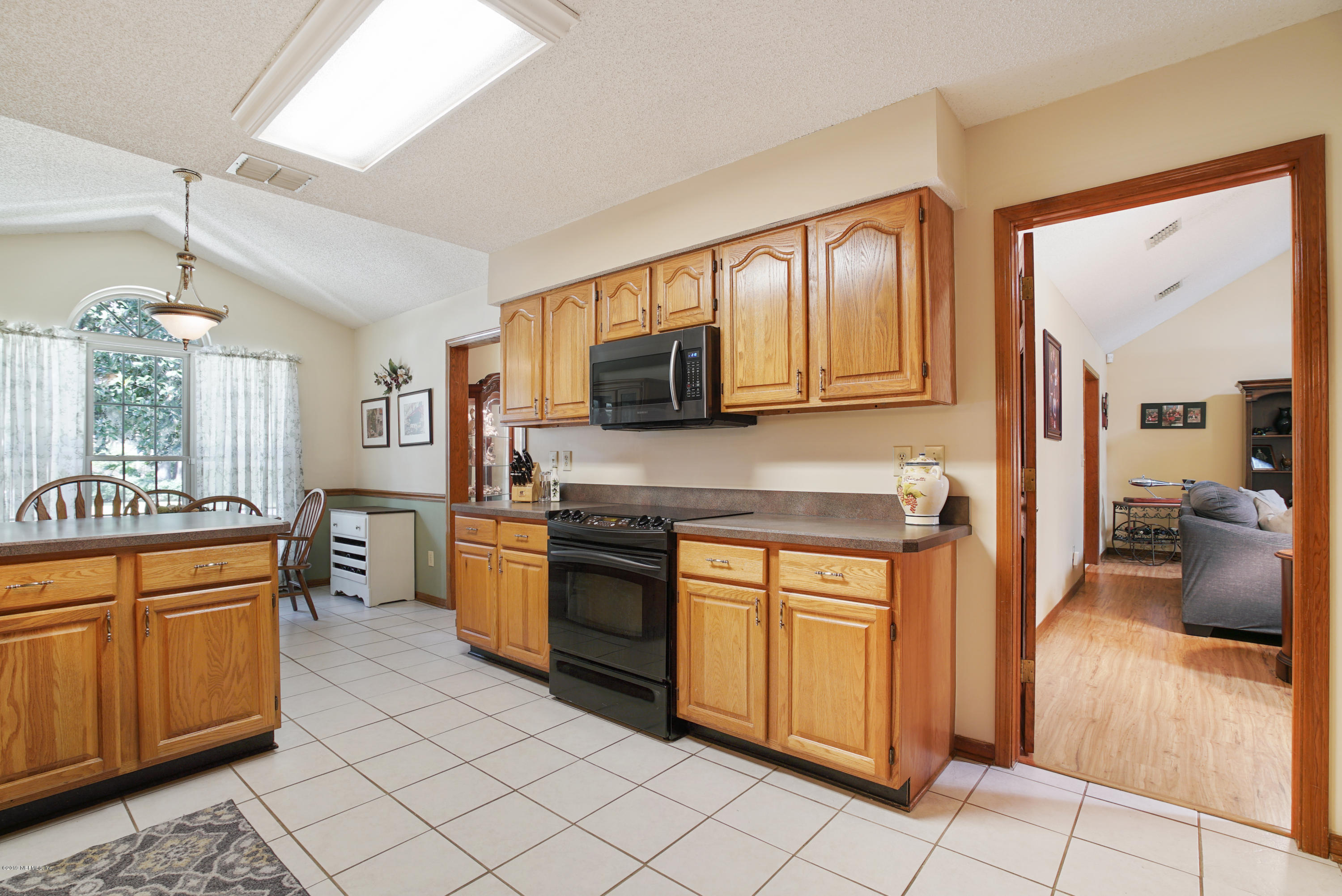 3165 Nautilus Road Middleburg, FL 32068 - Photo 12 of 35 a kitchen with stainless steel appliances granite countertop a stove top oven sink and cabinets