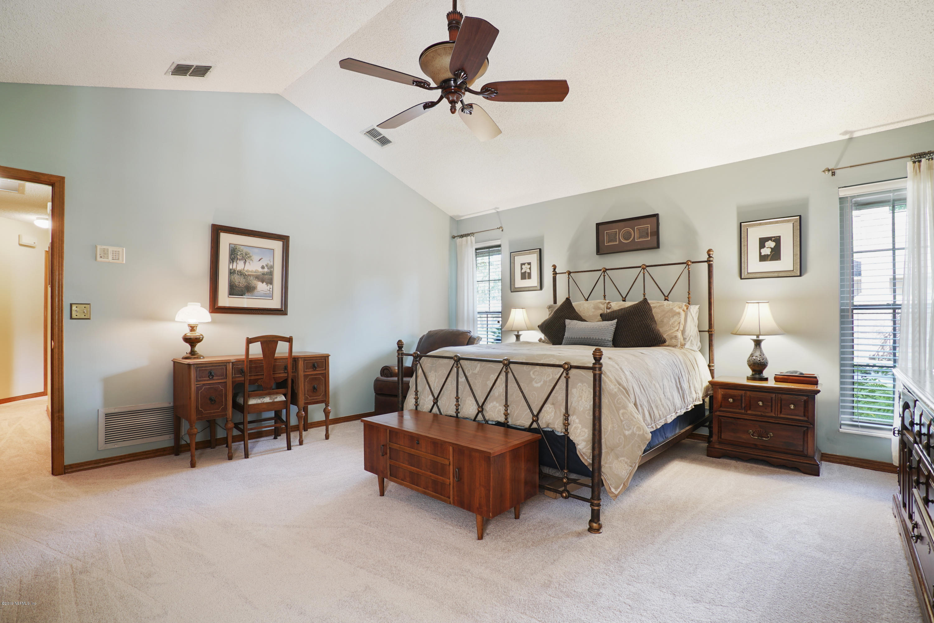 3165 Nautilus Road Middleburg, FL 32068 - Photo 23 of 35 a bedroom with a bed and a table