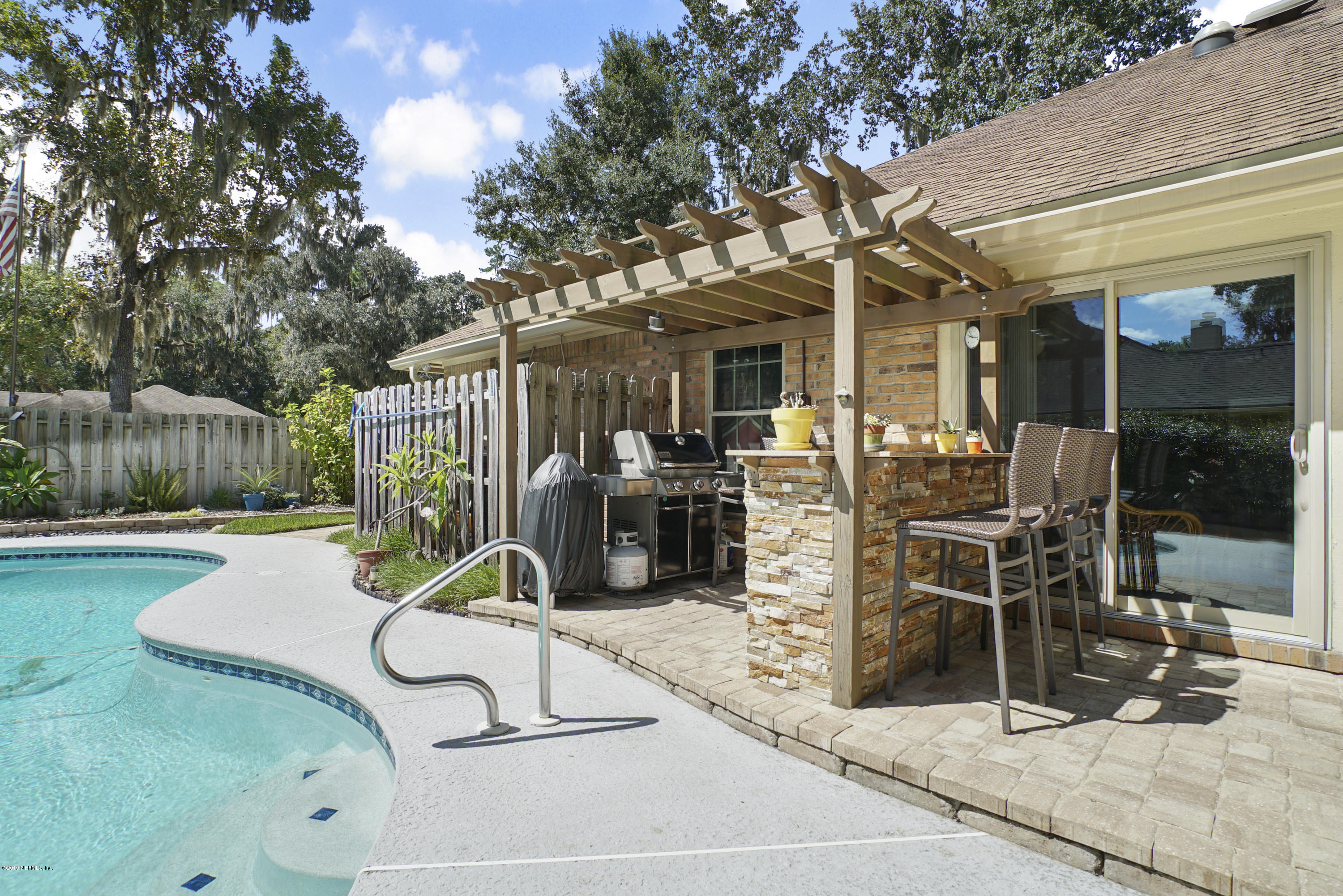 3165 Nautilus Road Middleburg, FL 32068 - Photo 30 of 35 a view of a patio with a table and chairs