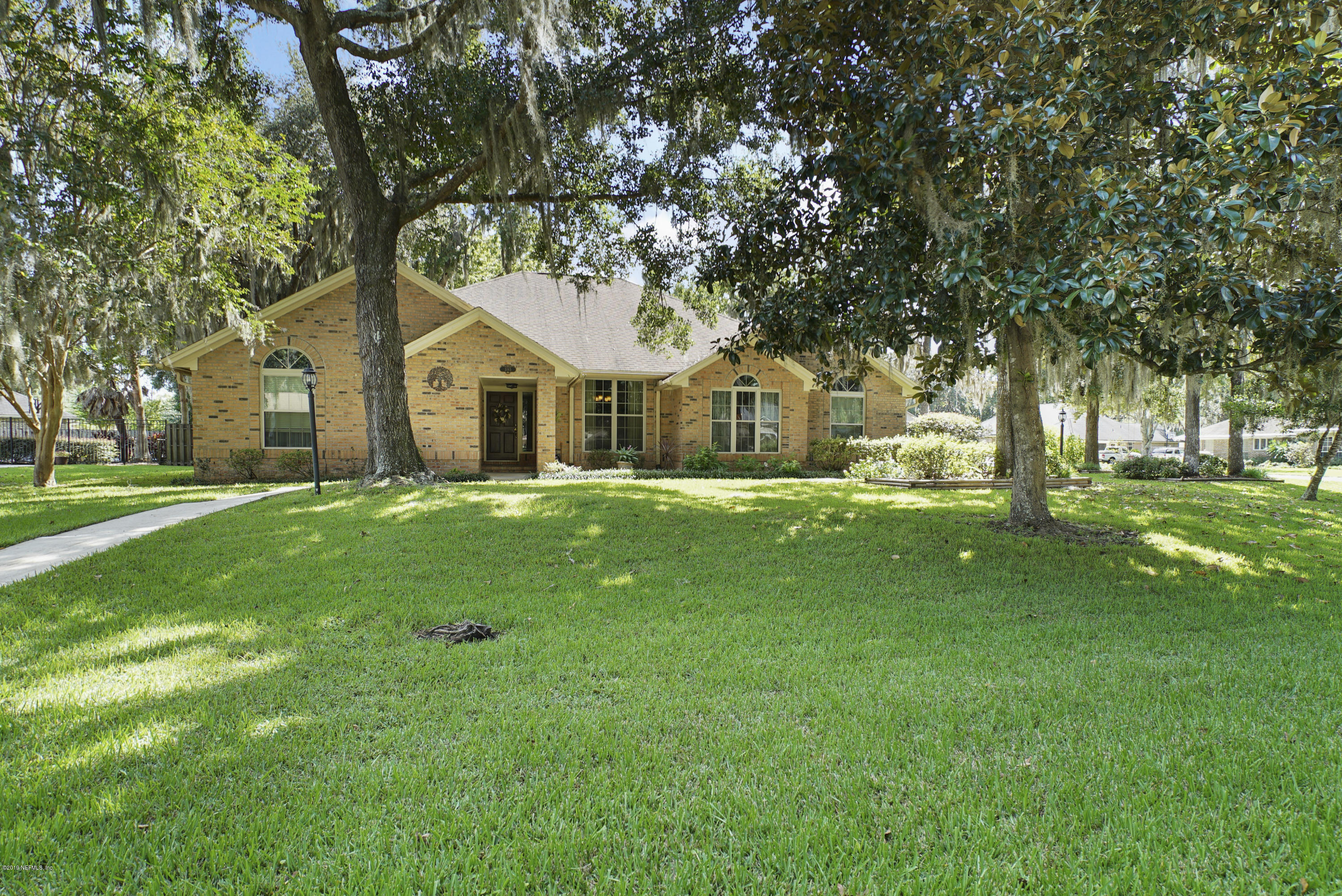 3165 Nautilus Road Middleburg, FL 32068 - Photo 3 of 35 a front view of a house with a yard