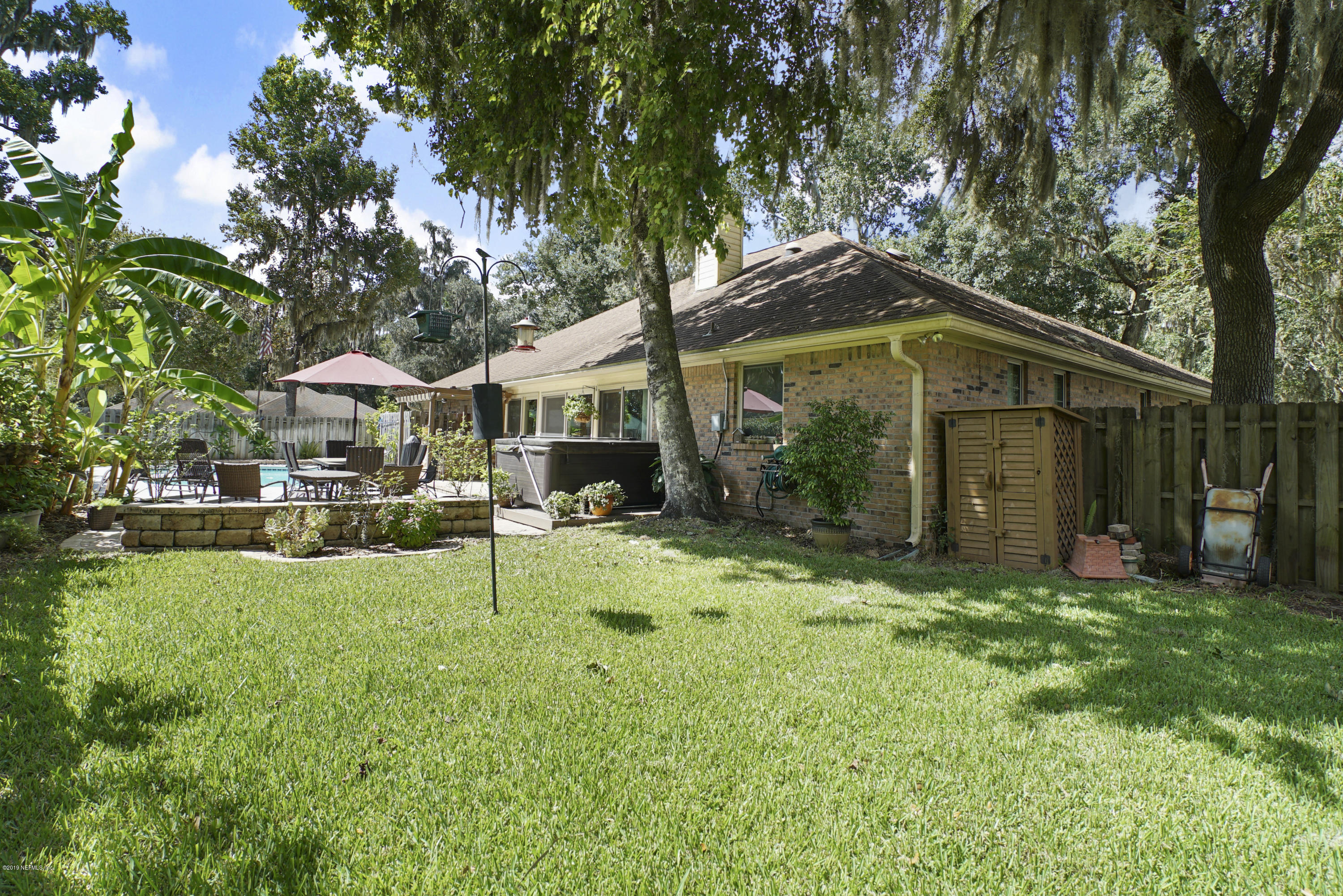 3165 Nautilus Road Middleburg, FL 32068 - Photo 33 of 35 a backyard of a house with yard and outdoor seating