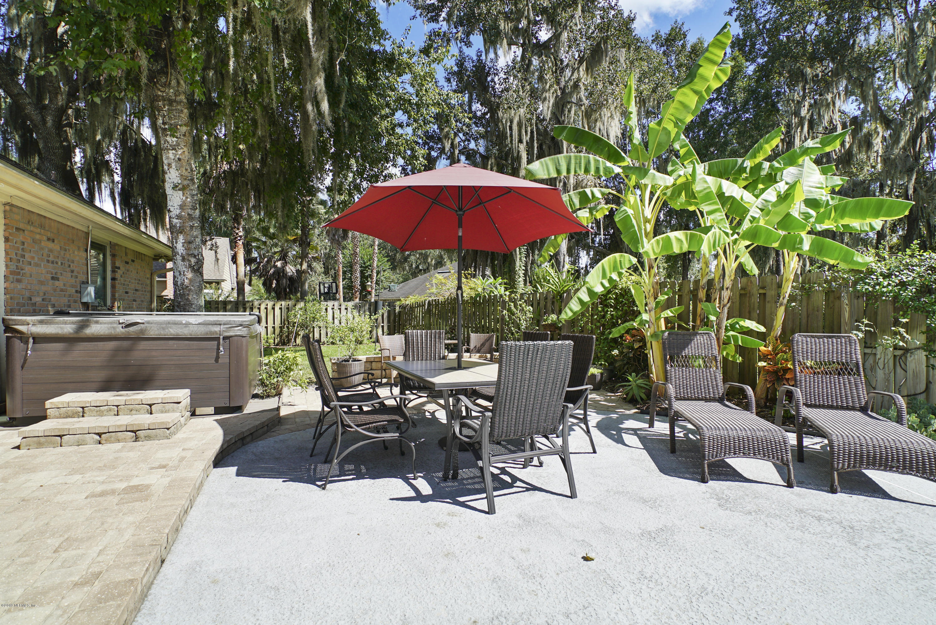 3165 Nautilus Road Middleburg, FL 32068 - Photo 35 of 35 a view of a patio with a table and chairs under an umbrella