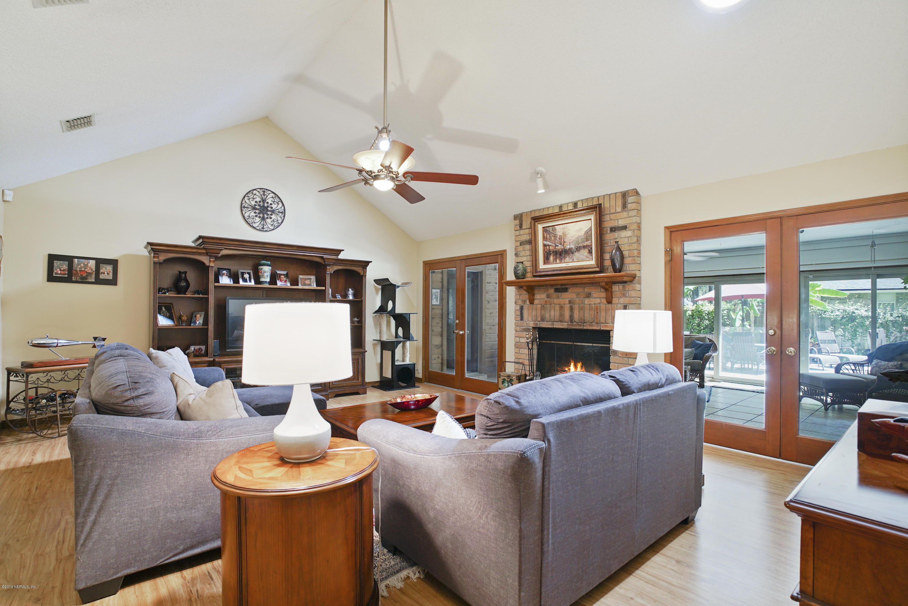 3165 Nautilus Road Middleburg, FL 32068 - Photo 10 of 35 a living room with furniture a fireplace and a large window