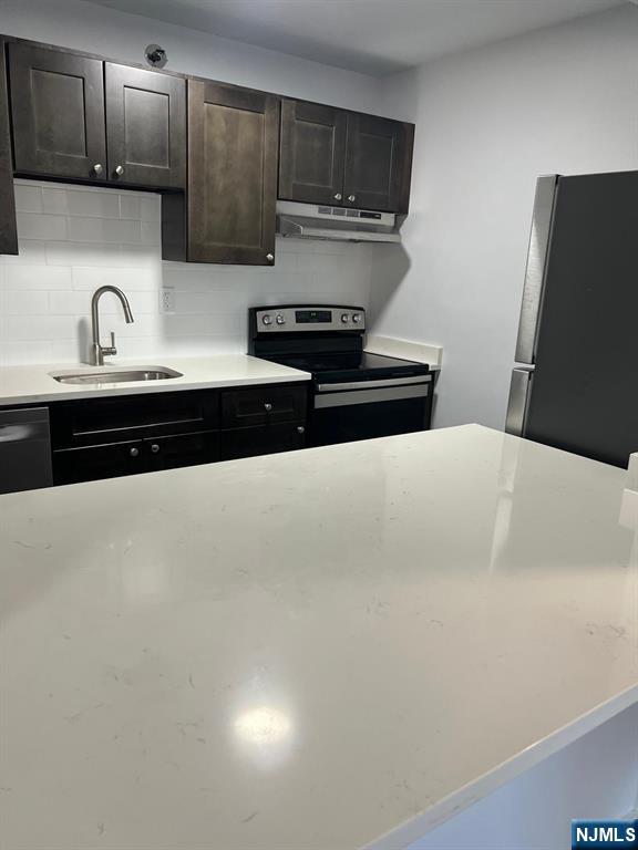 47 Polifly Road, Unit 1A Hackensack, NJ 07601 - Photo 11 of 12 a kitchen with stainless steel appliances a sink and a stove