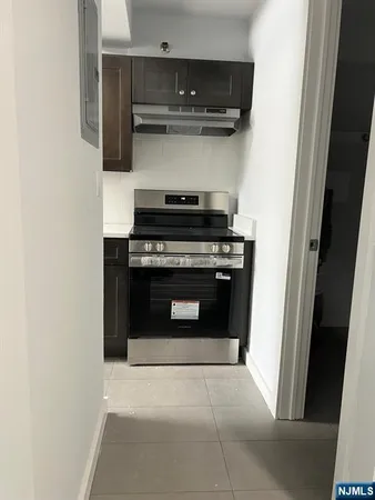 a stove top oven sitting inside of a kitchen