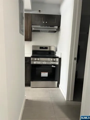 a stove top oven sitting inside of a kitchen