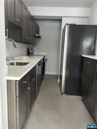a kitchen with a sink and a refrigerator