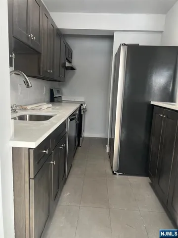 a kitchen with a sink and a refrigerator