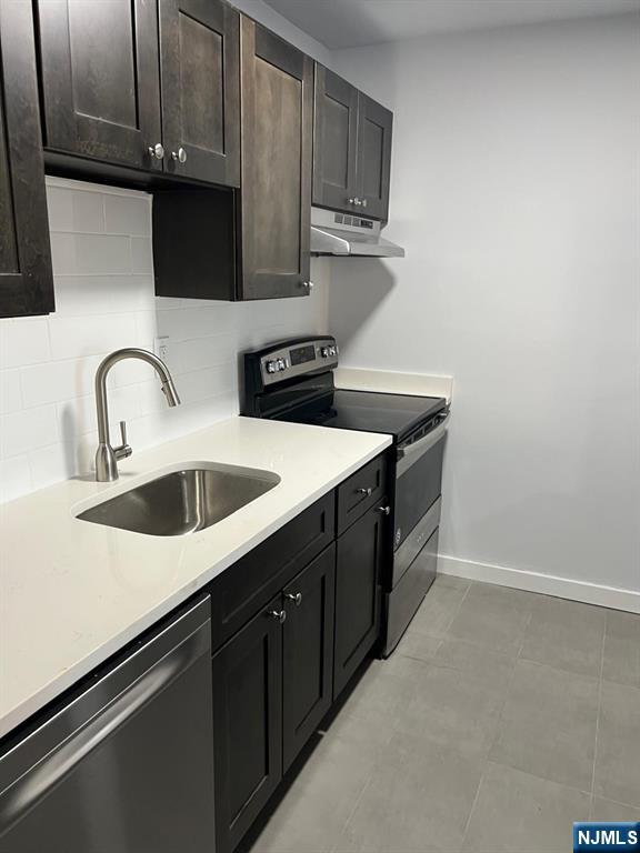 47 Polifly Road, Unit 1A Hackensack, NJ 07601 - Photo 3 of 12 a kitchen with stainless steel appliances granite countertop a sink and a stove