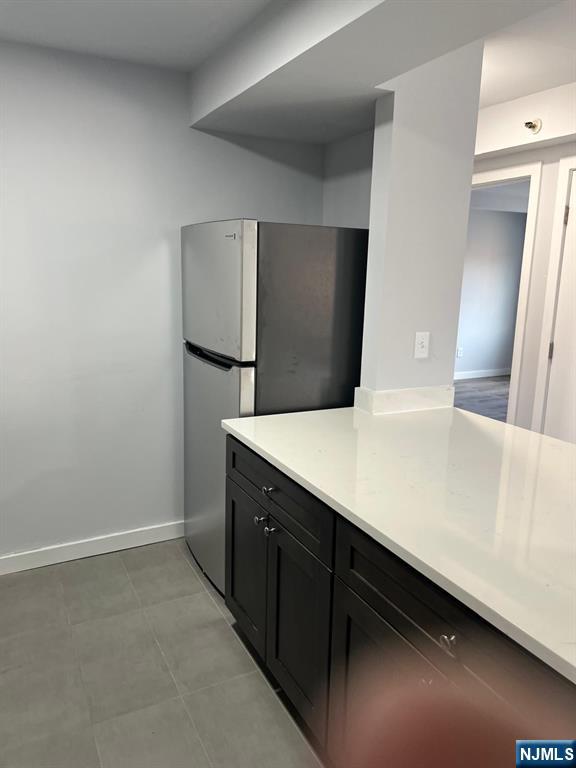 47 Polifly Road, Unit 1A Hackensack, NJ 07601 - Photo 4 of 12 a kitchen with a counter top and refrigerator