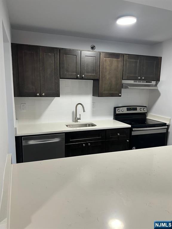 47 Polifly Road, Unit 1A Hackensack, NJ 07601 - Photo 5 of 12 a kitchen with stainless steel appliances granite countertop a sink a stove and cabinets