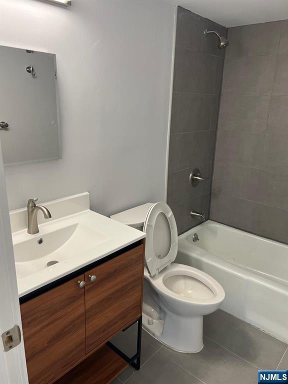 47 Polifly Road, Unit 1A Hackensack, NJ 07601 - Photo 7 of 12 a bathroom with a toilet a sink and bathtub