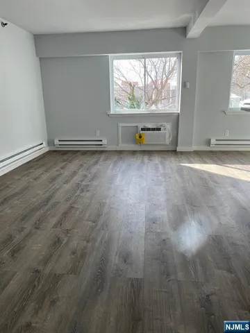 an empty room with large windows