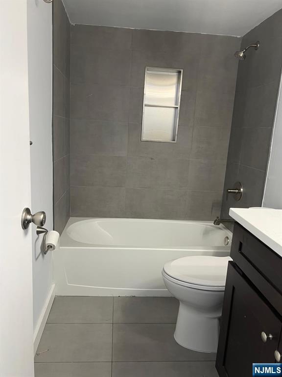 47 Polifly Road, Unit 1A Hackensack, NJ 07601 - Photo 9 of 19 a bathroom with a sink a toilet and a bathtub