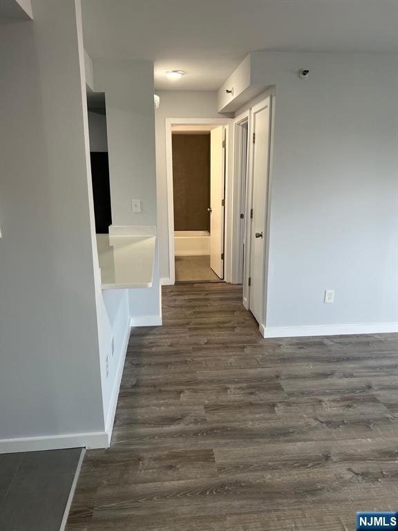 47 Polifly Road, Unit 1A Hackensack, NJ 07601 - Photo 9 of 12 a view of a hallway with wooden floor and staircase